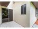 Exterior view of the patio with a sliding glass door and white stucco siding at 112 Waterwood Dr, Yalaha, FL 34797