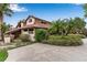 Charming single-story home with lush landscaping, a tile roof, and a welcoming entrance, showcasing curb appeal at 112 Waterwood Dr, Yalaha, FL 34797