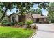 Charming brick home with well-manicured landscaping, green lawn, and a spacious driveway at 112 Waterwood Dr, Yalaha, FL 34797