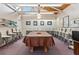 Bright game room featuring a large table, rows of seats, and a wood beam ceiling at 112 Waterwood Dr, Yalaha, FL 34797