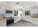 Bright kitchen features white cabinets, stainless steel appliances, and beautiful wood countertops at 112 Waterwood Dr, Yalaha, FL 34797