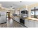 Kitchen featuring stainless steel appliances, light wood countertops, and modern backsplash at 112 Waterwood Dr, Yalaha, FL 34797