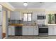 Galley kitchen with stainless steel appliances, wood countertops, and modern backsplash at 112 Waterwood Dr, Yalaha, FL 34797
