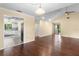 Open-concept living area with hard wood floors, access to the kitchen, and vaulted ceilings at 112 Waterwood Dr, Yalaha, FL 34797