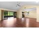 Bright living room featuring hard wood floors, a ceiling fan, and sliders to the screen room at 112 Waterwood Dr, Yalaha, FL 34797