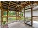 This covered patio features a serving bar and a lovely view of the backyard at 112 Waterwood Dr, Yalaha, FL 34797