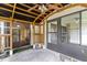 Covered patio with wood beams, concrete flooring, and access to the interior at 112 Waterwood Dr, Yalaha, FL 34797