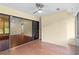 This sunroom features hardwood flooring, a sliding glass door, and custom shelving at 112 Waterwood Dr, Yalaha, FL 34797