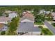 An aerial view of a home featuring a modern roof with a screened in lanai at 1122 Magrath Way, The Villages, FL 32162