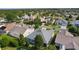 An aerial view of a home featuring a modern roof with a screened in lanai at 1122 Magrath Way, The Villages, FL 32162