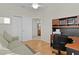 Bedroom featuring a ceiling fan, closet and a desk with shelving and a printer at 1122 Magrath Way, The Villages, FL 32162