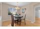 Cozy dining area with wood floors, a chandelier, and a modern art piece at 1122 Magrath Way, The Villages, FL 32162