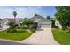 Charming single-story home with a well-manicured lawn and mature landscaping at 1122 Magrath Way, The Villages, FL 32162