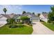 Charming single-story home with a well-manicured lawn and mature landscaping at 1122 Magrath Way, The Villages, FL 32162