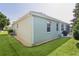 Exterior view of the home, featuring lush greenery and a screened in lanai at 1122 Magrath Way, The Villages, FL 32162
