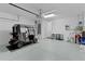 Spacious garage featuring a golf cart and ample storage space at 1122 Magrath Way, The Villages, FL 32162