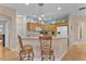 Well-appointed kitchen with a breakfast bar, ample cabinet space, and modern appliances at 1122 Magrath Way, The Villages, FL 32162