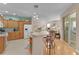 Open kitchen with bar seating that offers seamless flow to the home's living spaces at 1122 Magrath Way, The Villages, FL 32162