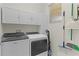 Bright laundry room with modern appliances and storage cabinets at 1122 Magrath Way, The Villages, FL 32162