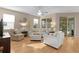 Bright living room with hardwood floors, comfortable seating, and plenty of natural light at 1122 Magrath Way, The Villages, FL 32162