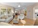 Open-concept living area seamlessly connecting the kitchen, dining, and living spaces at 1122 Magrath Way, The Villages, FL 32162