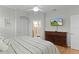 Spacious main bedroom with an ensuite bathroom and a TV mounted on the wall at 1122 Magrath Way, The Villages, FL 32162