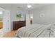 Bright main bedroom with laminate floors, a TV mounted on the wall, and plenty of closet space at 1122 Magrath Way, The Villages, FL 32162