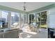 Inviting sunroom with lots of natural light, ceiling fan and comfortable seating at 1122 Magrath Way, The Villages, FL 32162