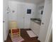 Bathroom features neutral cabinets, wood floors, and a decoratively painted yellow chair at 114 Azalea Trl, Leesburg, FL 34748