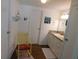 Bathroom features neutral cabinets, wood floors, and a decoratively painted yellow chair at 114 Azalea Trl, Leesburg, FL 34748