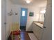 Bathroom features neutral cabinets, wood floors, and a decoratively painted yellow chair at 114 Azalea Trl, Leesburg, FL 34748