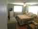 Bedroom with wood floors, ceiling fan, and dresser at 114 Azalea Trl, Leesburg, FL 34748