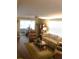 Inviting living room featuring a comfortable sofa, recliner, and warm, natural lighting at 114 Azalea Trl, Leesburg, FL 34748