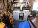 Utility room with washer, dryer, and sink, plus ample storage and organization space at 114 Azalea Trl, Leesburg, FL 34748