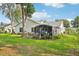 Beautiful backyard featuring a patio, lush lawn, and screened in porch at 1214 Loch Rannoch Ct, Leesburg, FL 34788