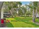 Lush backyard with screened-in porch, offering ample green space and privacy at 1214 Loch Rannoch Ct, Leesburg, FL 34788