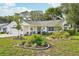 Charming single-story home featuring a well-manicured lawn, lovely landscaping, and inviting curb appeal at 1214 Loch Rannoch Ct, Leesburg, FL 34788