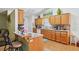 Well-lit kitchen with wood cabinetry, breakfast bar, and open layout at 1214 Loch Rannoch Ct, Leesburg, FL 34788
