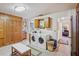 Functional laundry room with side-by-side washer and dryer, built-in storage, and ample counter space at 1214 Loch Rannoch Ct, Leesburg, FL 34788