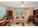 Sitting room with neutral colors, bright sunlight, and built-in shelving at 1214 Loch Rannoch Ct, Leesburg, FL 34788