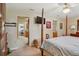 Inviting primary bedroom featuring neutral colors, a ceiling fan, and an adjoining private bathroom at 1214 Loch Rannoch Ct, Leesburg, FL 34788