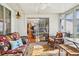 Well-lit sunroom with wicker chairs and a view to the kitchen and dining room at 1214 Loch Rannoch Ct, Leesburg, FL 34788
