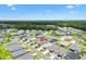 Expansive aerial view of a neighborhood featuring well-maintained homes and green spaces under a bright blue sky at 1225 Eunice St, The Villages, FL 34762