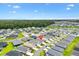 Community aerial view showing homes, manicured lawns, and lush green spaces in a neighborhood setting at 1225 Eunice St, The Villages, FL 34762