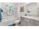 Bright bathroom with tub/shower combo and gray vanity with a white countertop at 1225 Eunice St, The Villages, FL 34762