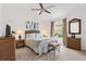 Bright bedroom featuring coastal decor, neutral walls, and a ceiling fan at 1225 Eunice St, The Villages, FL 34762
