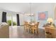 Bright dining area with wood floors, sliding door access to outside, and classic decor at 1225 Eunice St, The Villages, FL 34762