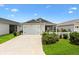Attractive single-story home with a well-maintained lawn, picket fence, and a convenient attached garage at 1225 Eunice St, The Villages, FL 34762