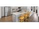Modern kitchen features breakfast bar seating and sleek, stainless steel appliances at 1225 Eunice St, The Villages, FL 34762