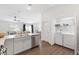 Open floor plan with modern kitchen featuring an island that flows to living areas at 1225 Eunice St, The Villages, FL 34762